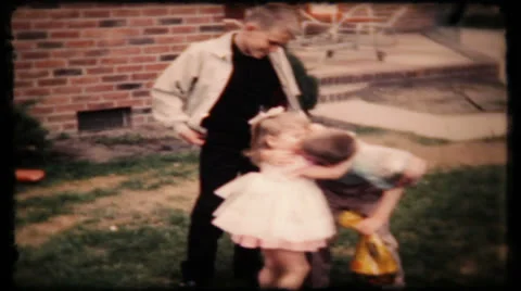 Brother kisses little sister while dad films 1950s vintage film home movie 216 Stock Footage 26118235