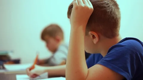 The brothers do their boring homework. They don’t want to write in a notebook. Stock Footage 99468482