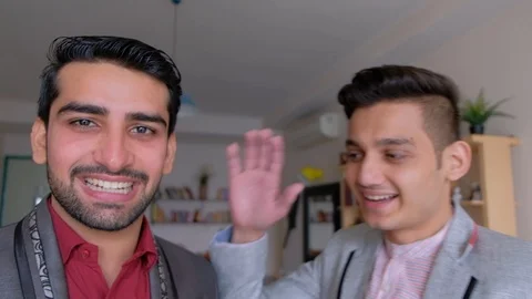 Brothers doing a video smart con-call on their portable communication device wit Stock Footage 101290859