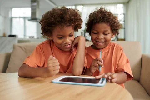 Brothers Drawing on Tablet Computer Stock Photos