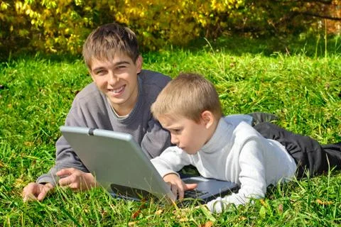 Brothers with notebook Stock Photos