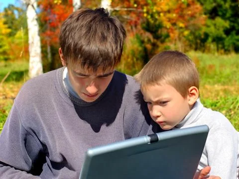 Brothers with notebook Stock Photos