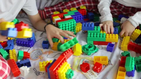 Brothers in pajamas playing constructor on the bed Stock Footage 61006112