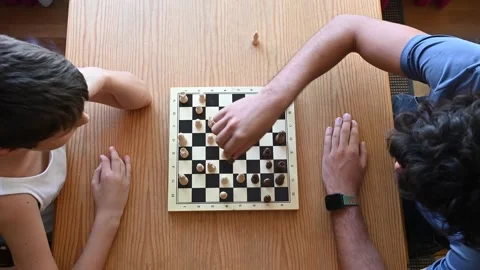 Brothers playing chess on a table, view from above. Stock Footage 343218707
