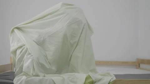 Brothers playing the ghost game under the bed sheet Video stock 163768695