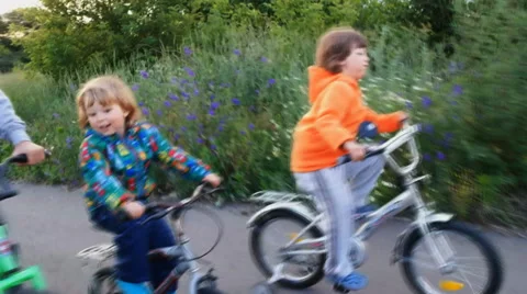 Brothers ride on bikes Stock Footage 39724631