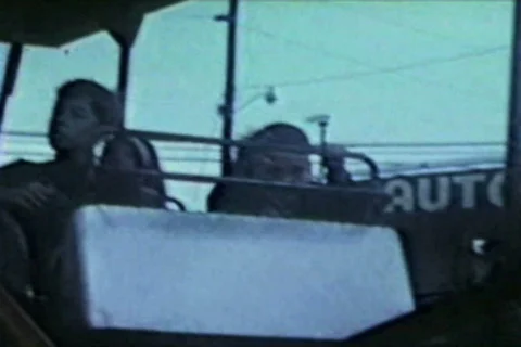 Brothers ride roller coaster at carnival Stock Footage