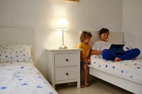 Brothers using tablet in bedroom Stock Photos