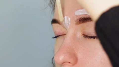 Brow master applying hot wax for brows epilation, lamination and waxing Stock Footage 149055424