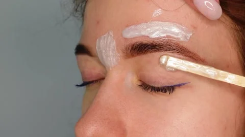 Brow master applying hot wax for brows epilation, lamination and waxing Stock Footage 149055425