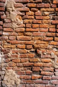 Brown aged brick wall with cracking parts. Stock Photos