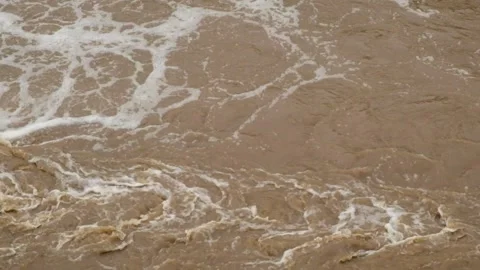 Brown and foamy waves of flooded river water Stock Footage 321320507
