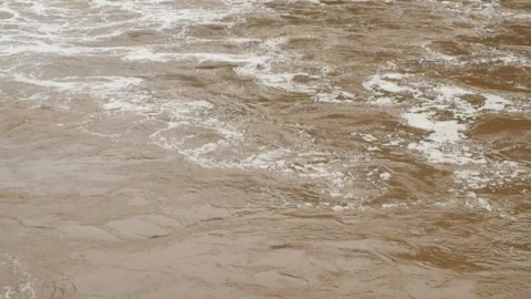 Brown and foamy waves of flooded river water Stock Footage 321320512