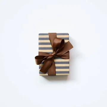Brown and navy stripe pattern gift box isolated on white background. top v... Stock Photos