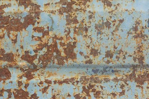 Brown and orange rust on old blue metal. Stock Photos