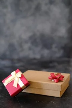 Brown and red gift boxes on dark background Stock Photos