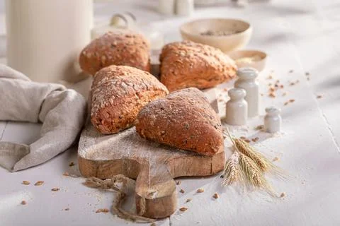 Brown and tasty triangular buns baked in a bakehouse. Stock Photos