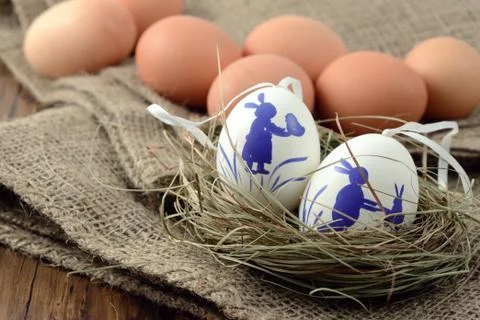 Brown and white easter eggs on burlap sack Stock Photos