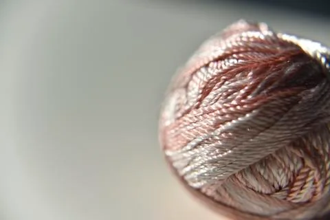 Brown and white silk thread on the plain background Stock Photos