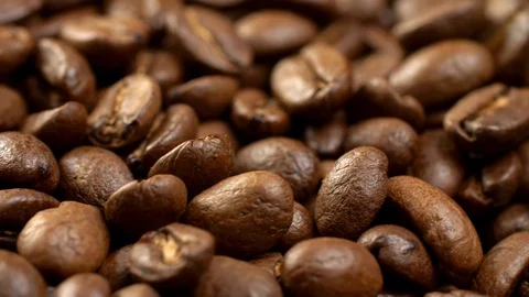 Brown appetizing roasted coffee beans on a rotating panel. Close-up shot, 4K Stock Footage 109473781