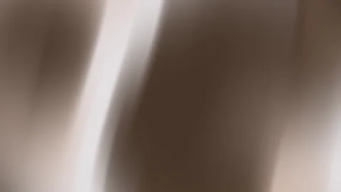 Brown background with blurred vertical white streaks. Video stock 292095007