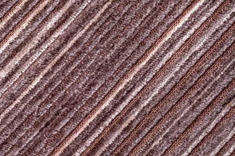 Brown background of a knitted textile material. Fabric with a striped texture Stock Photos