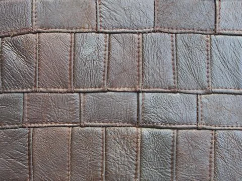Brown background of rectangles of various sizes and shades, leather texture. Stockfoto's