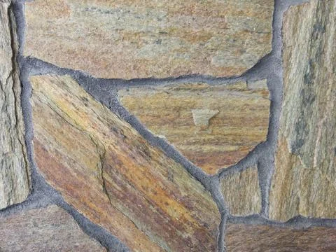 Brown background with stone texture. Stone vintage wall. Close-up. Stock Photos