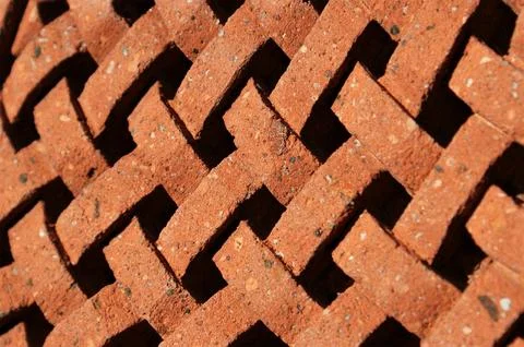 Brown background. The structure of the braid is carved into the stone. Stock Photos