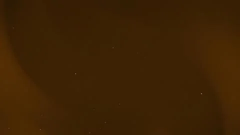 Brown background with subtle light speckles. Stock Photos