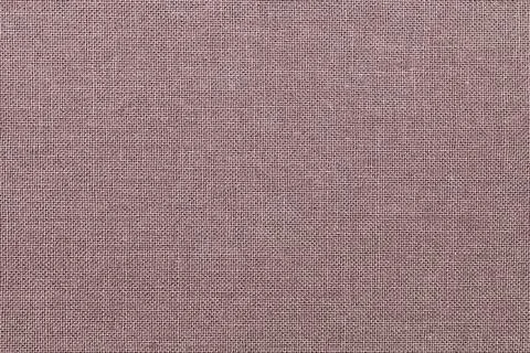 Brown background from a textile material with wicker pattern, closeup. Stock Photos