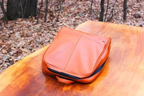 Brown Backpack Genuine Leather Backpack. or backpack on a wooden table in the Stock Photos