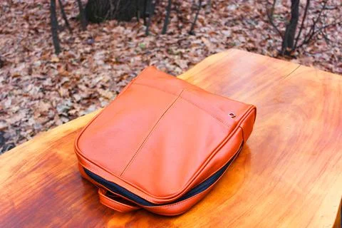 Brown Backpack Genuine Leather Backpack. or backpack on a wooden table in the Stock Photos