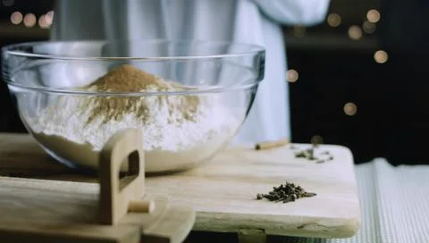 Brown Baking Spice Being Added to White Flour Stock Photos