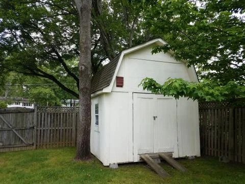 Brown bat box on white storage shed Stock Photos