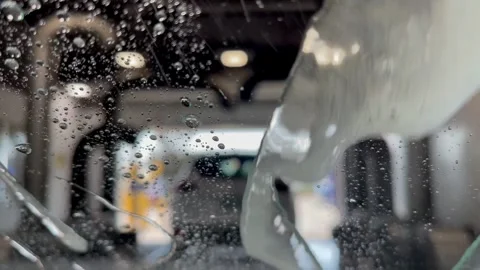Brown bear car wash. Automatic car wash in action - colorful foam, rinse, air Stock Footage 249145789
