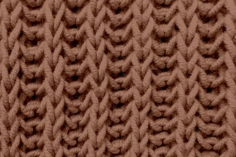 Brown beautiful knitted braid pattern light natural wool yarn, knitted text.. Stock Photos
