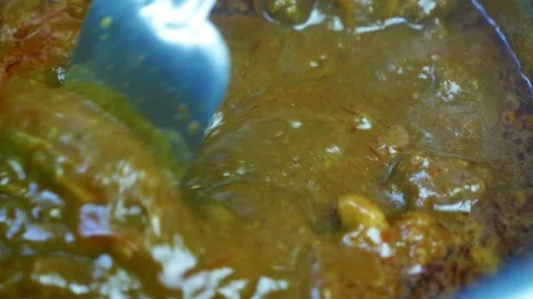 Brown beef curry coocking, tender beef pieces coated in a rich, glossy brow.. Video stock 346466843