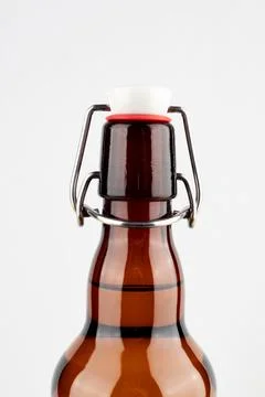 Brown beer bottle with bugle plug isolated on white background. Stock Photos