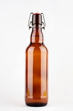 Brown beer bottle with bugle plug isolated on white background. Stock Photos