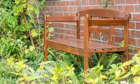 Brown bench in front of a house Stock Photos
