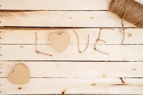 Brown biodegradable gift boxes in the shape of a heart and the word love made Stock Photos