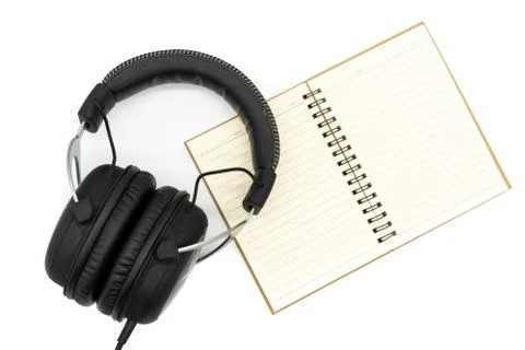 The brown book is open, placed under all black headphones, placed in the midd Stock Photos