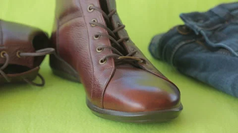 Brown boots and blue denim jean on isolated green screen Stock Footage 60640988