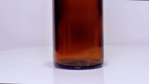 Brown bottle, sanitaiser, close up, slide up Stock Footage