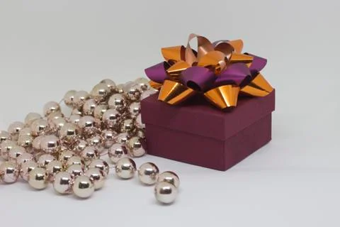 Brown box with orange bow on a light background Stock Photos