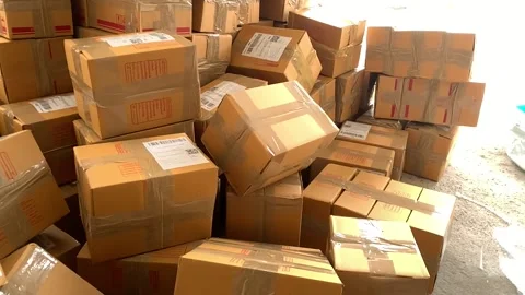 Brown box package falling on pile of parcel slow motion on a sunny day. Thailand Stock Footage 225125198
