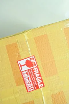 Brown box packaging with warning symbol Stock Photos