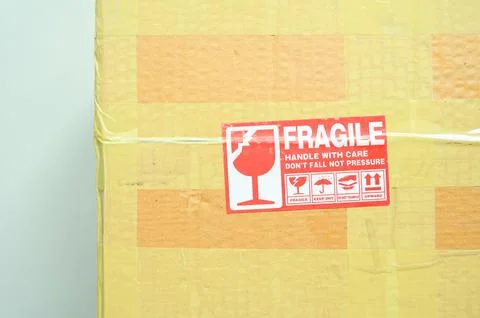 Brown box packaging with warning symbol Stock Photos