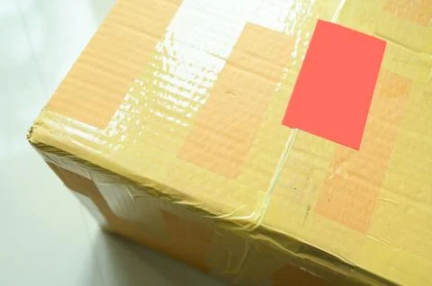 Brown box packaging with warning symbol Foto stock